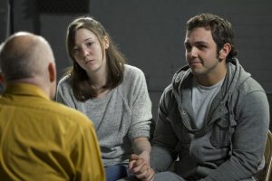 couples holding hands in a therapy session