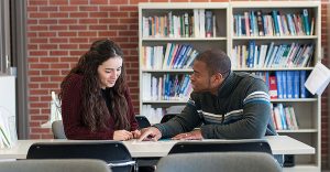 man and woman in conversation at library